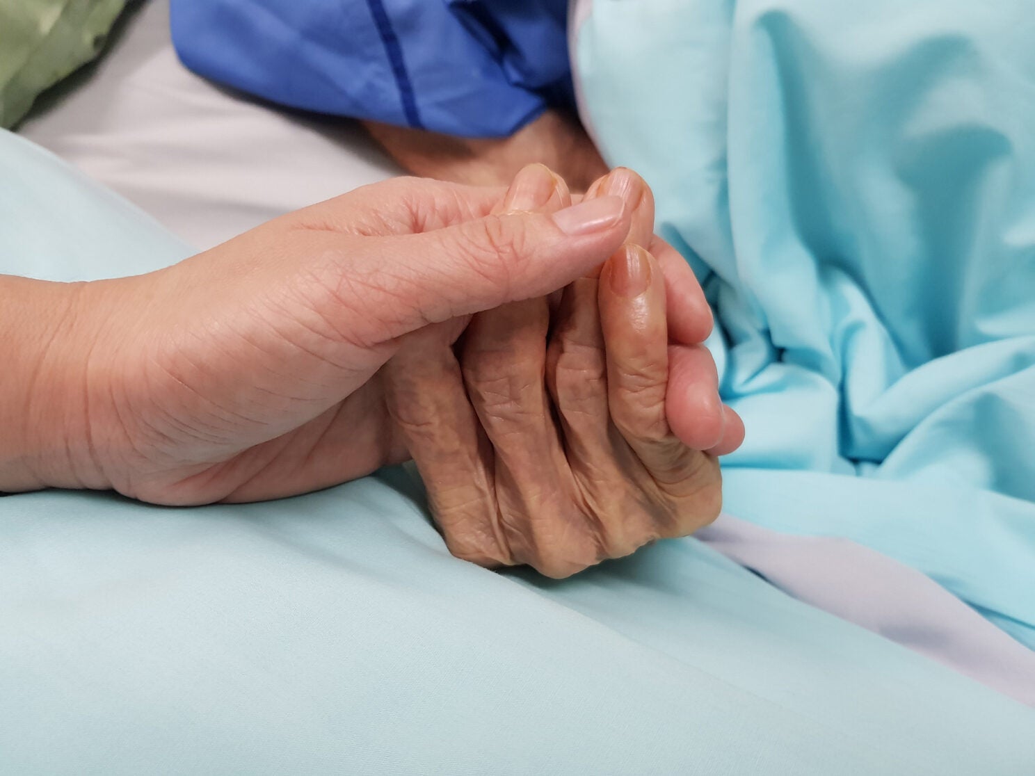 Detail of healthcare worker holding patient